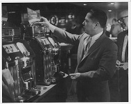 Photograph of James Riddle 'Jimmy Hoffa' Playing a Silver Quarter Gaming Machine