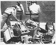 Photograph of Police Destroying Confiscated Gaming Machines with Sledgehammer