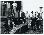 Photograph of County Sheriff Smashing Confiscated Gaming Machine with Sledgehammer